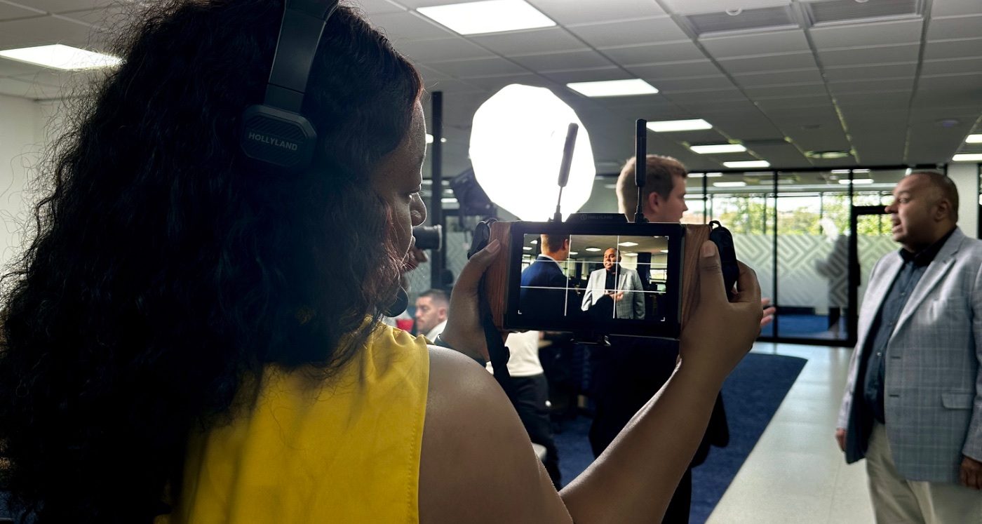 A ThinkStory crew member watching a client interview on a field monitor