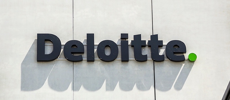 The Deloitte logo on the side of an office building